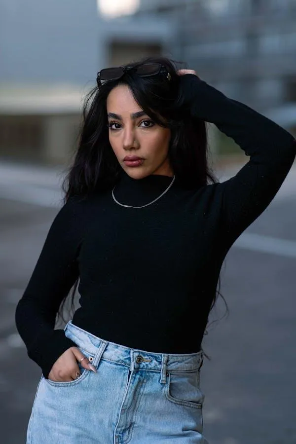 Confident Woman in a Black Top and Jeans on a City Street