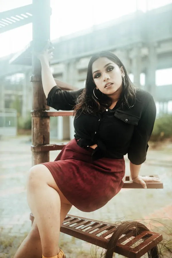 Confident Woman in Black Top and Red Skirt on the Staircase
