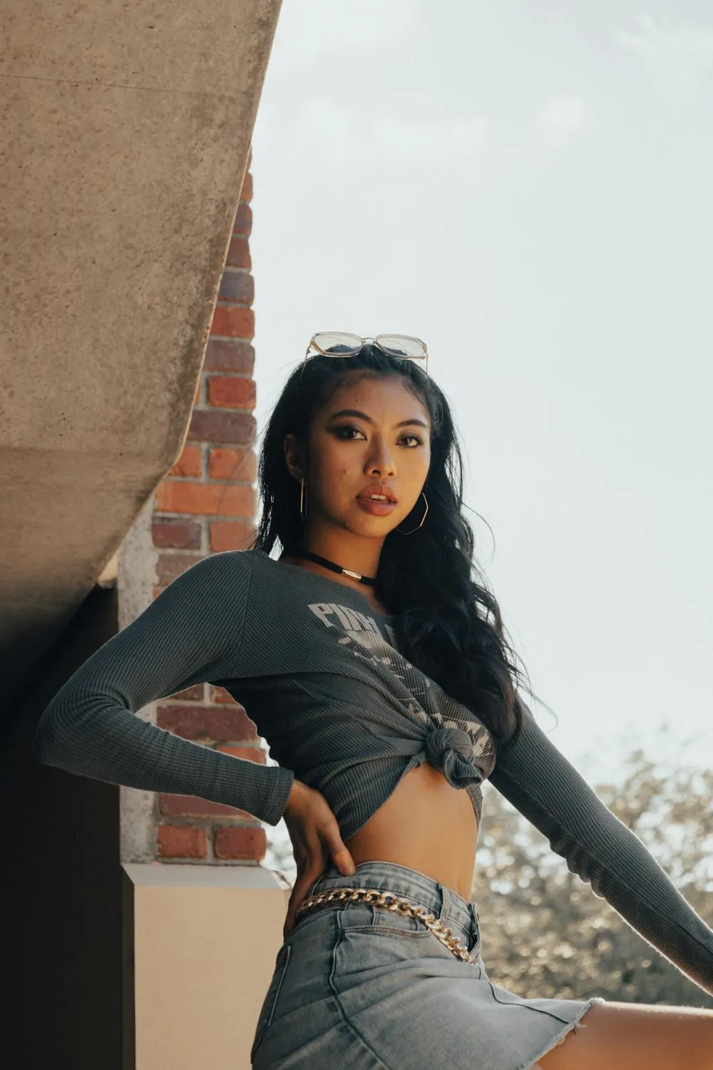 Confident Woman in a Green Top Posing on an Urban Rooftop