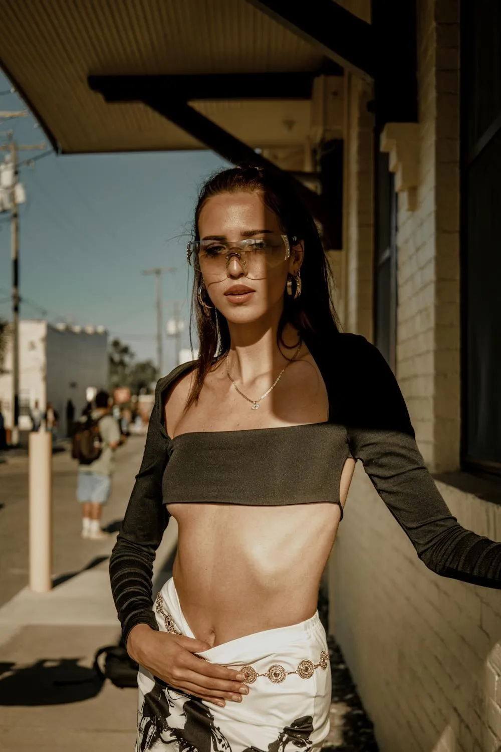 Confident Woman in Open Jacket Standing on a City Balcony