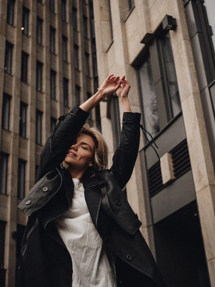 Confident Woman Posing in a Cityscape Wearing a Blazer Image