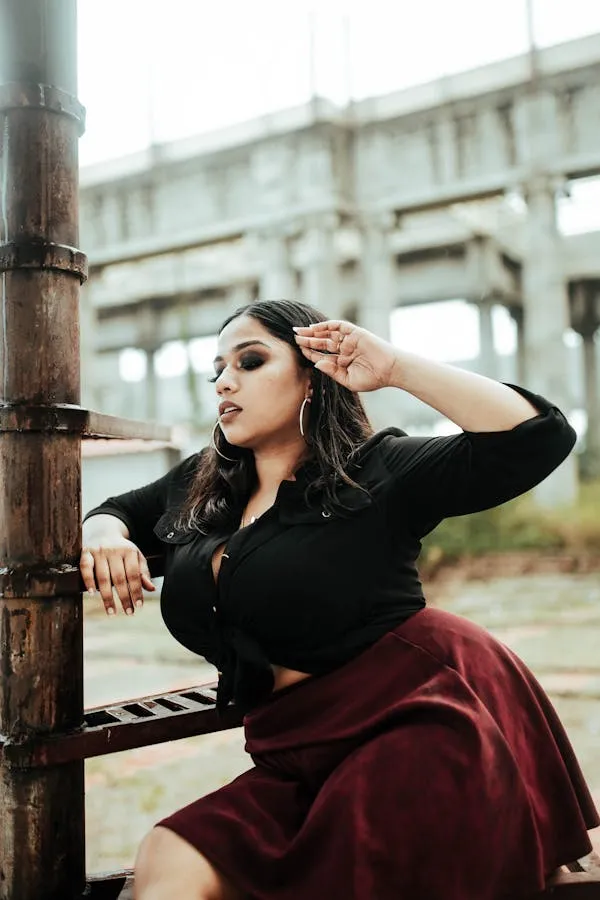 Confident Woman Posing Near an Industrial Outdoor Setting