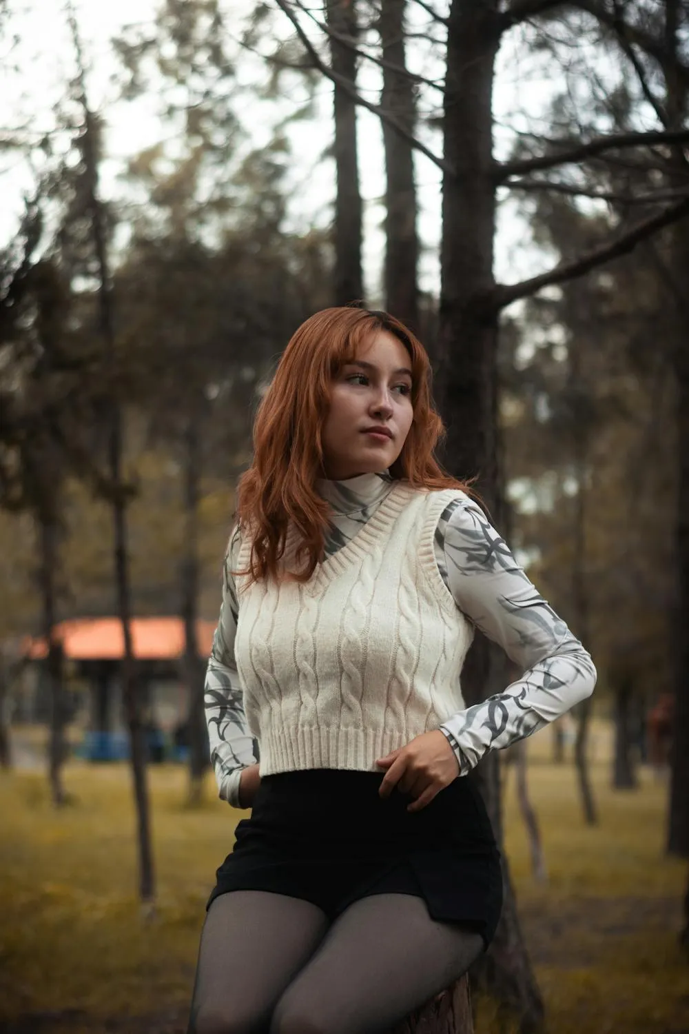 Confident Woman Posing Outdoors in a Black and White Outfit