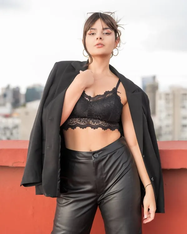 Confident Woman Posing on the Rooftop in Black Leather Set