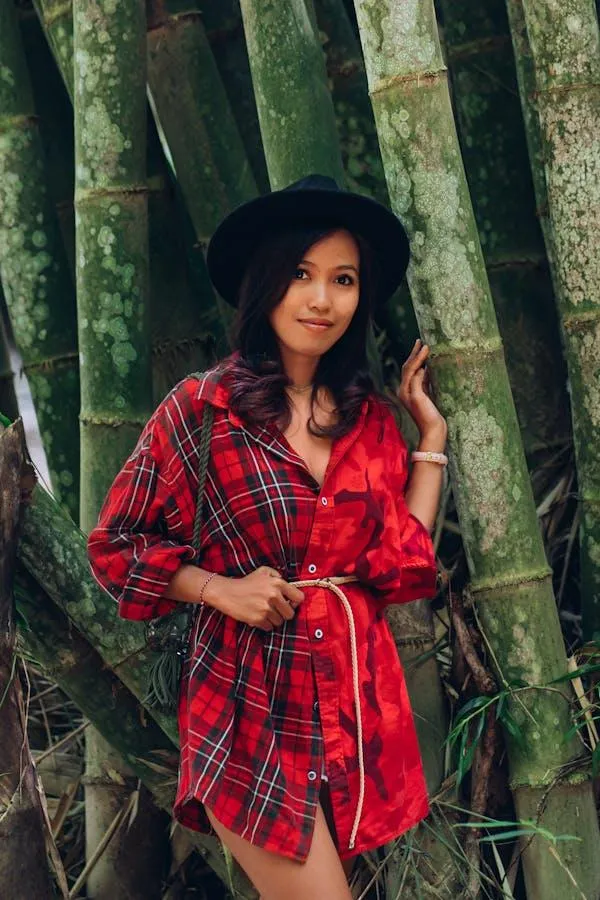 Confident Woman Wearing Red Plaid Shirt in a Bamboo Forest