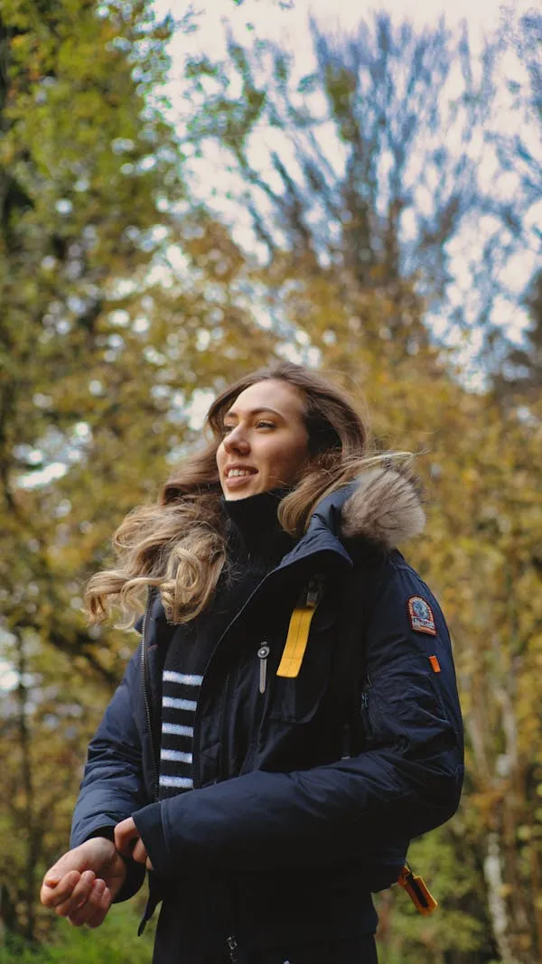 Confident Woman in Winter Jacket Posing Outdoors in Autumn