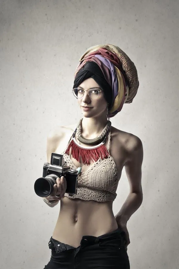 Creative Woman in Headwrap Holding Vintage Camera Wallpaper