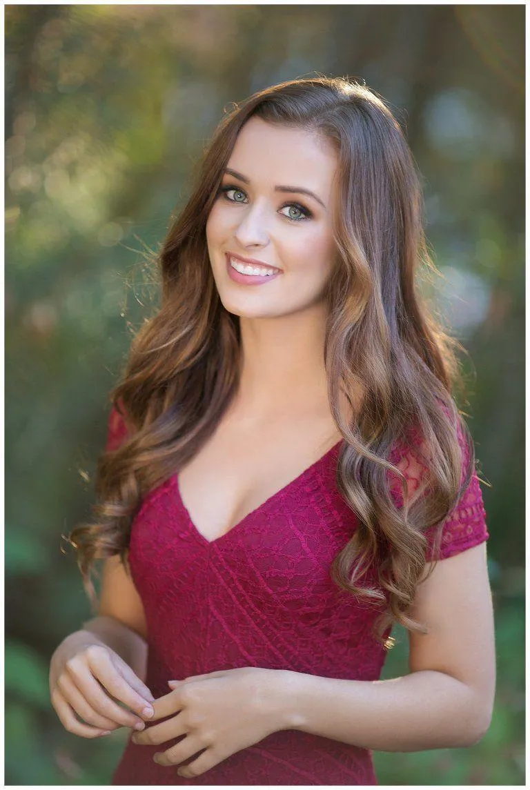 Cute Woman in a Green Dress Holding a White Chair Wallpaper