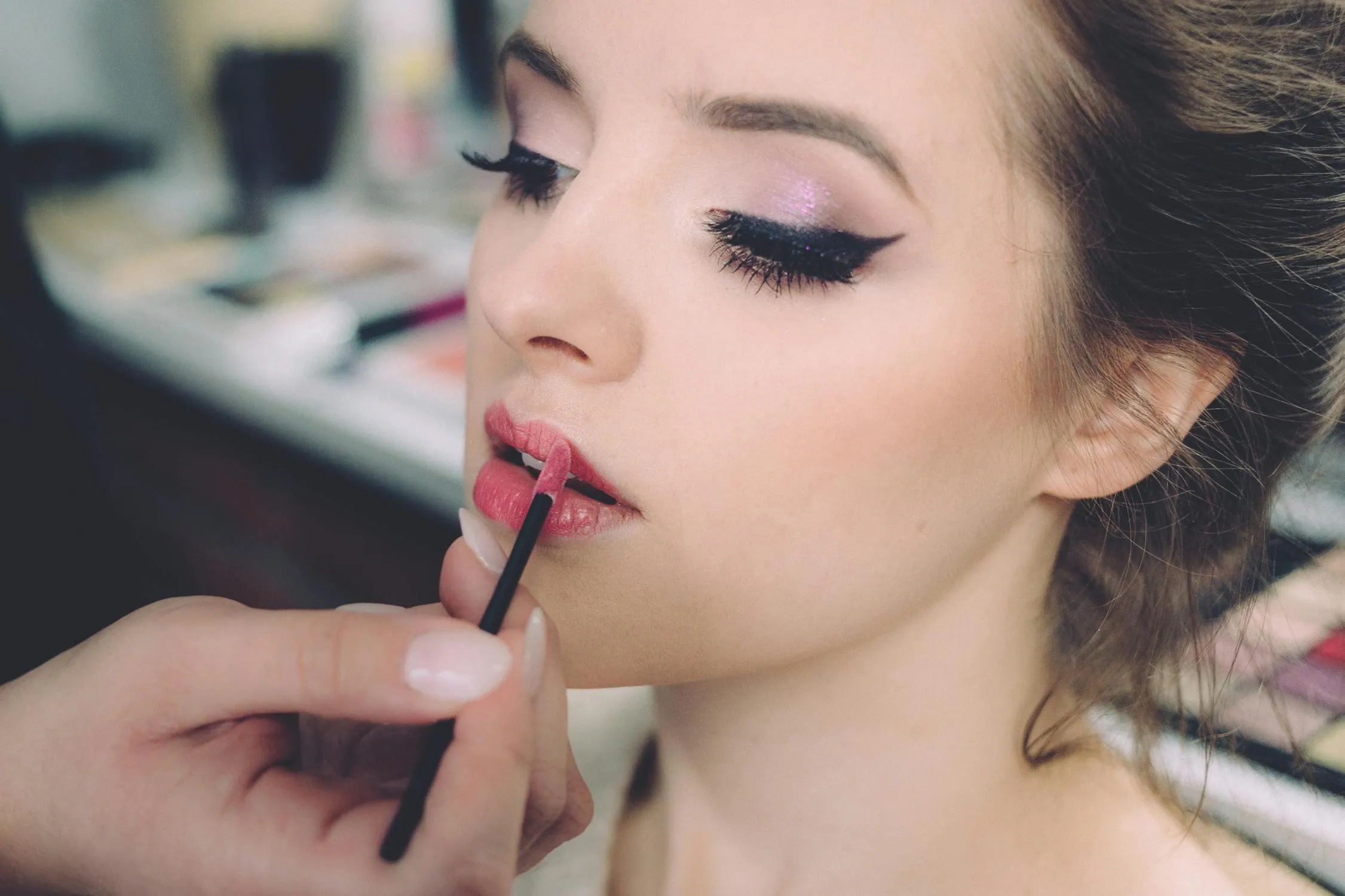 Cute Woman Is Applying Lipstick While Getting Ready Inside
