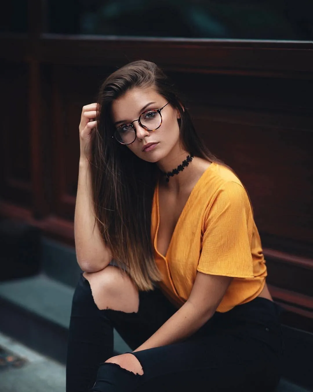 Cute Woman Leaning on a Blue Door in Casual White and Jeans