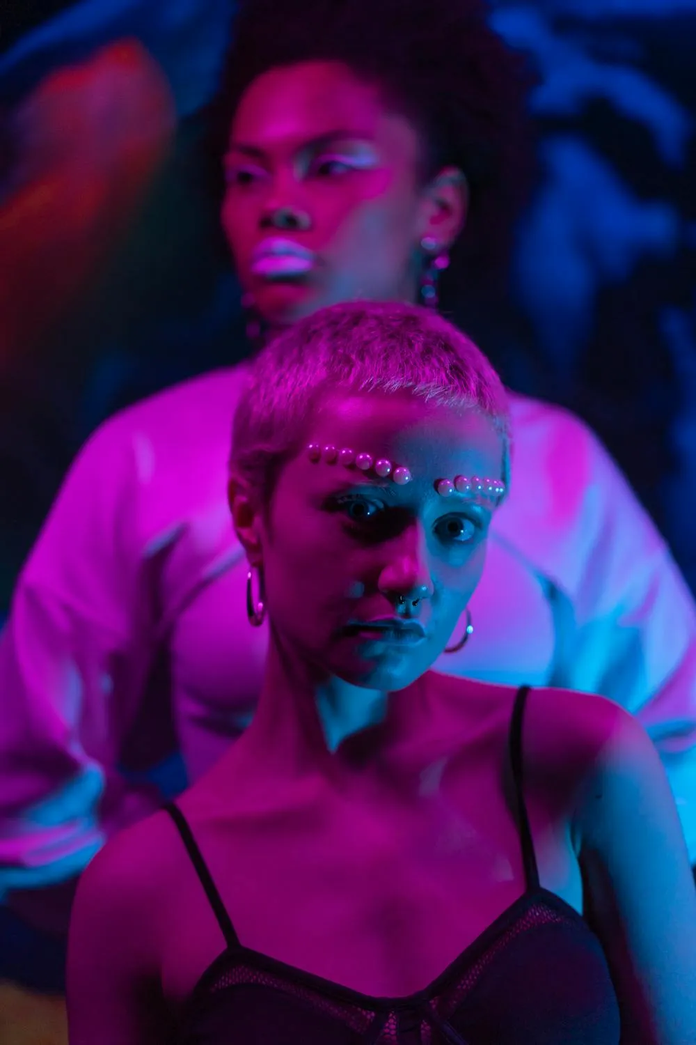 Dramatic Lighting Portrait of Two Women Together Wallpaper