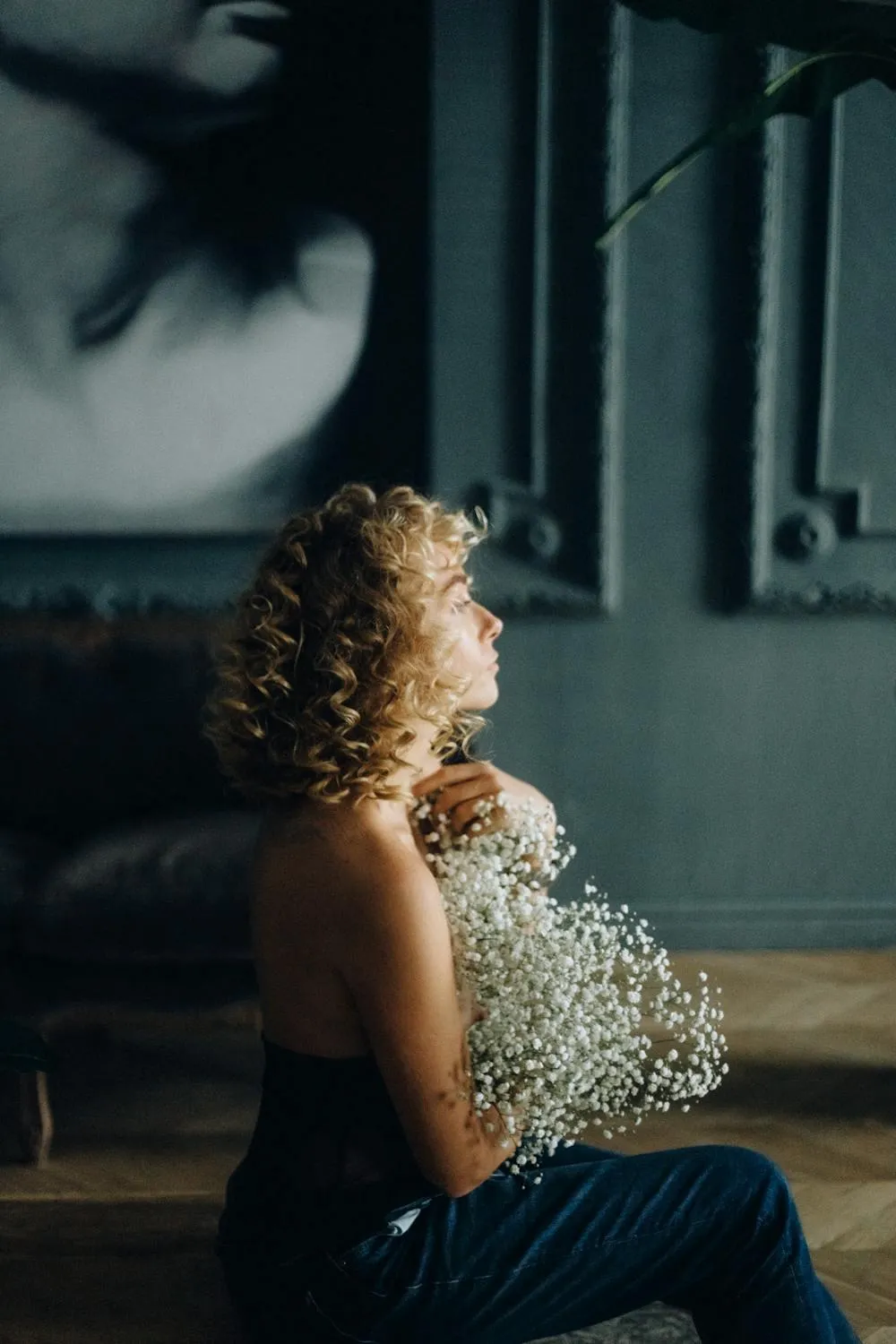 Dramatic Portrait of a Woman with Curls in Light Wallpaper