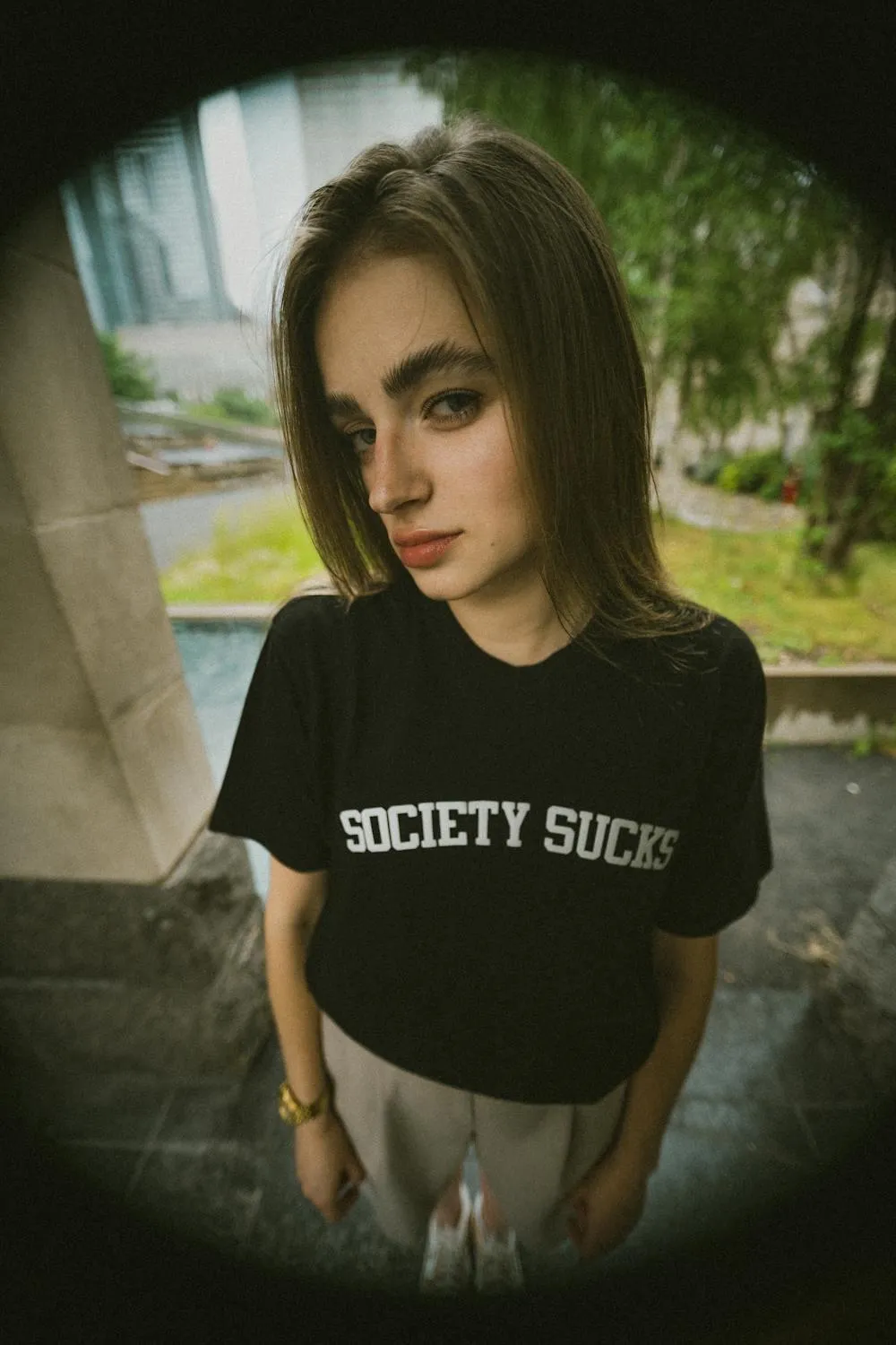 Edgy Teen Model in a Graphic Tee Posing in Natural Light