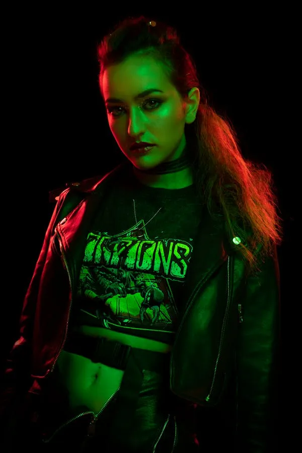 Edgy Woman Glowing Under Red and Green Neon Lights Wallpaper