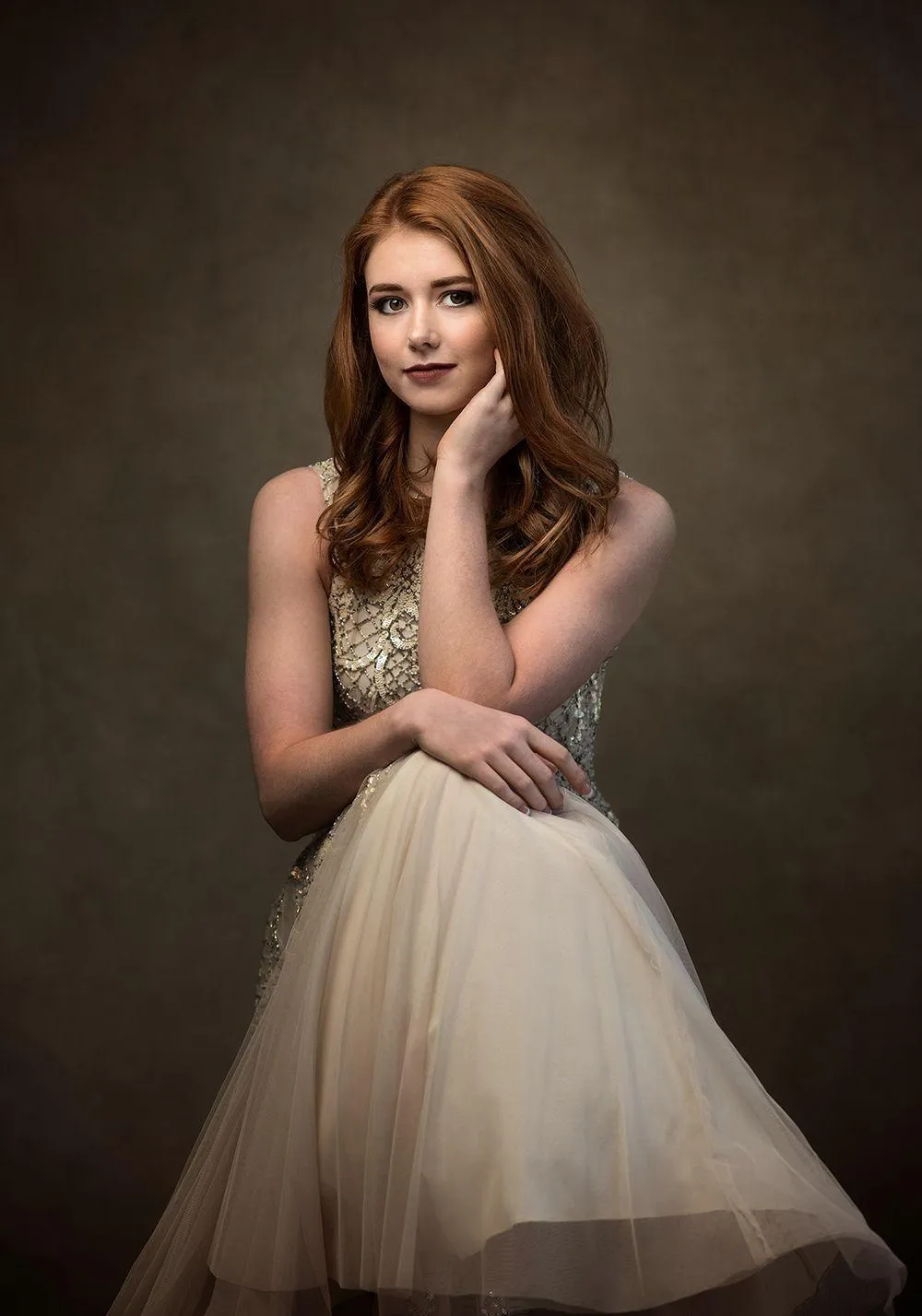 Elegant Woman in a Beige Gown Posing For a Formal Photo