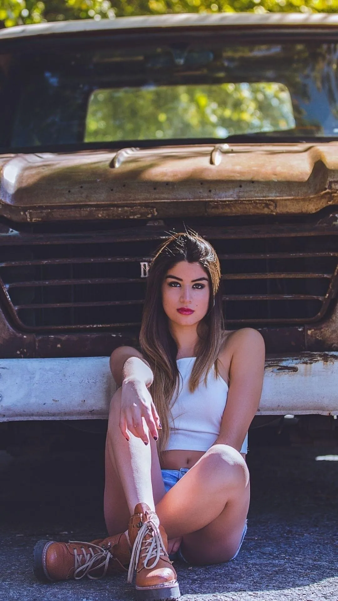 Elegant Woman Posing Next To a Red Luxury Sports Car Image