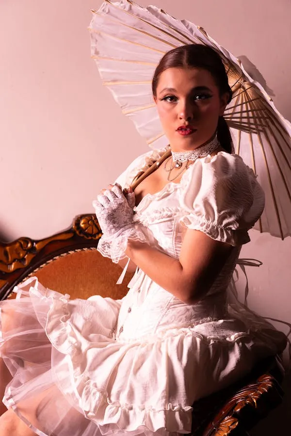 Elegant Woman Posing in a Pink Dress with a Lace Parasol