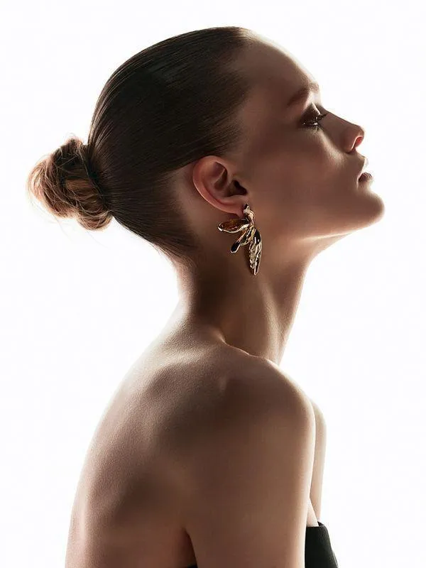 Elegant Woman in Profile View with Hair Tied and Earrings