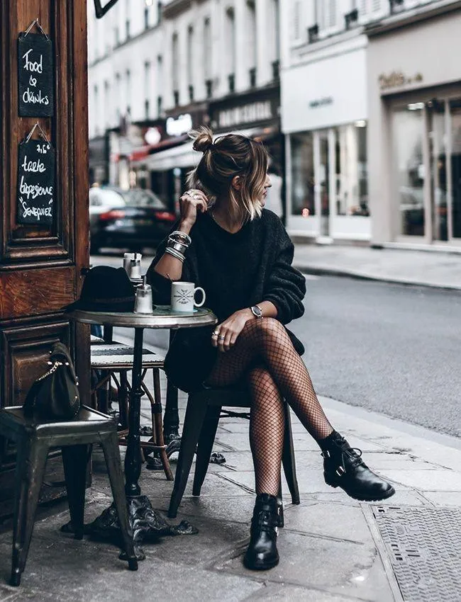 Elegant Woman Sitting At a Cafe Table on a City Sidewalk