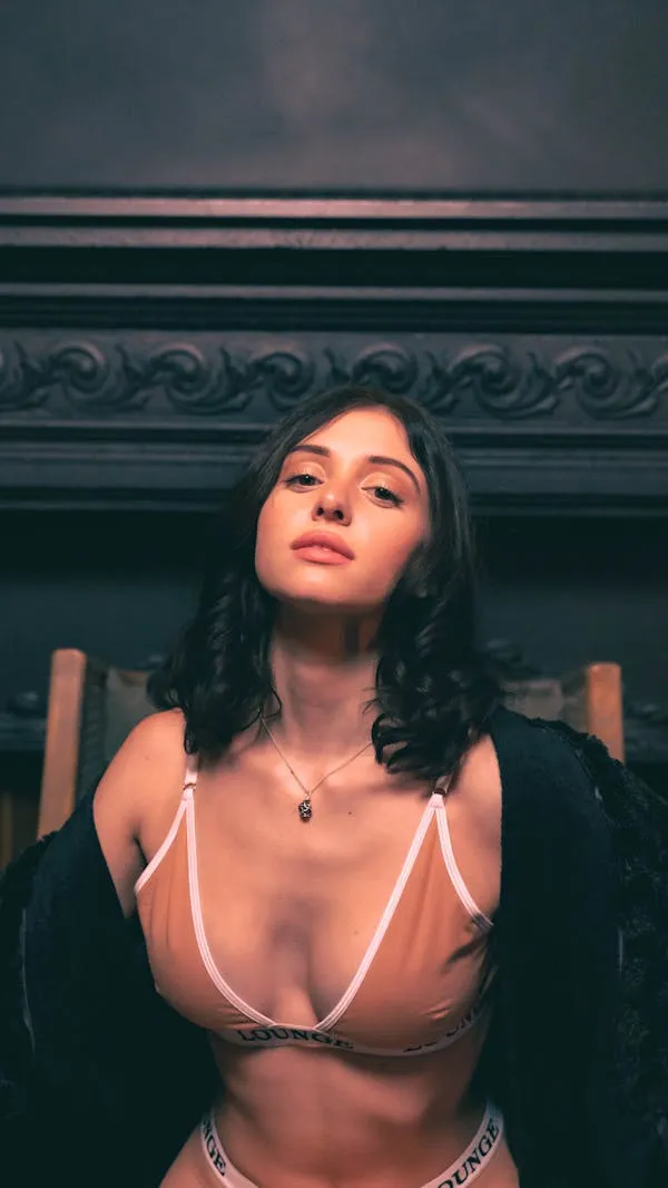 Elegant Woman Sitting on the Stairs Wearing Revealing Dress