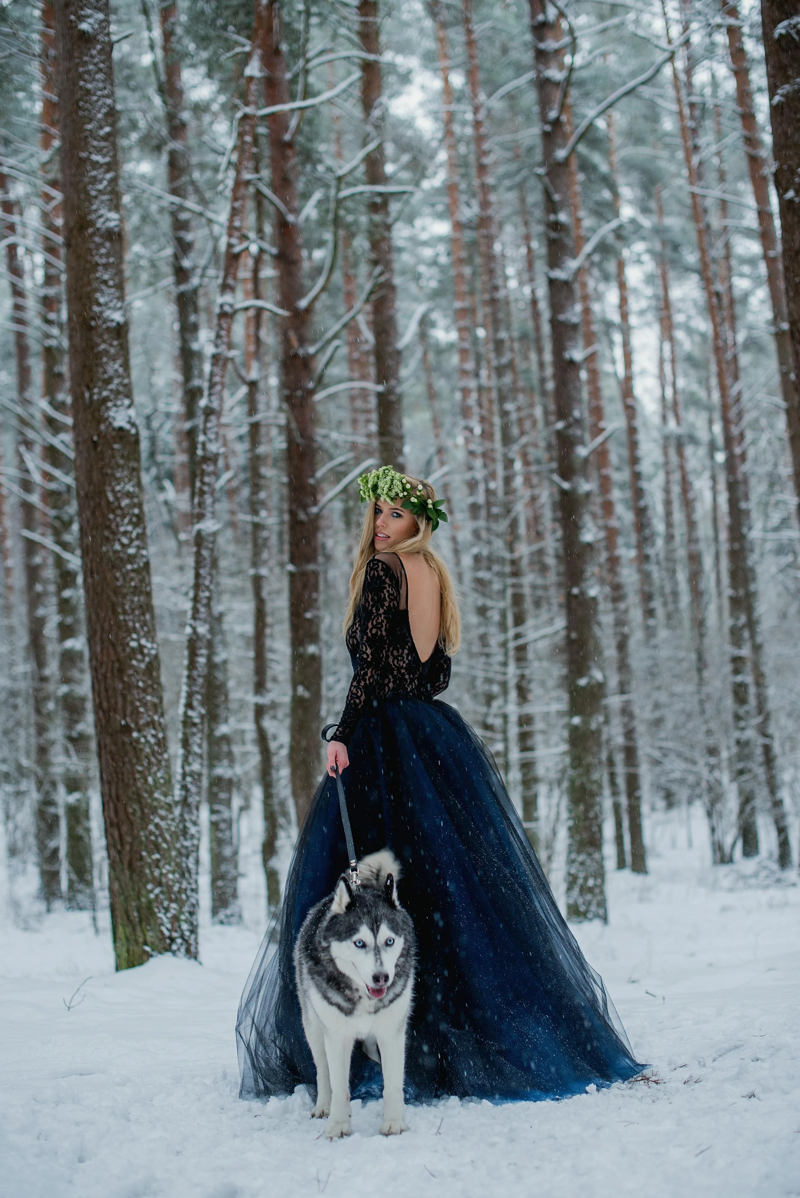 Elegant Woman in a Snowy Forest Walking with Her Dog Image