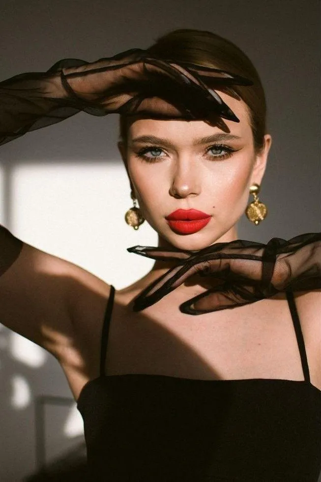 Fashion Model in a Black Dress with Sleek Hairstyle Posing