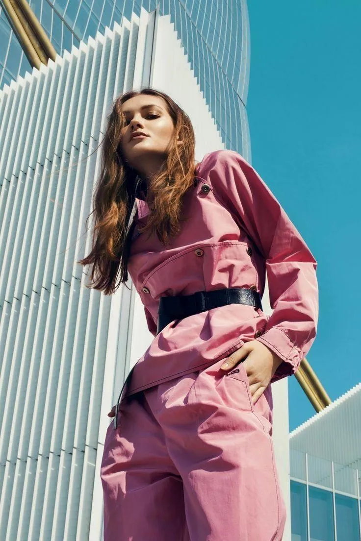 Fashion Model in a Pink Outfit Posing in an Urban Cityscape
