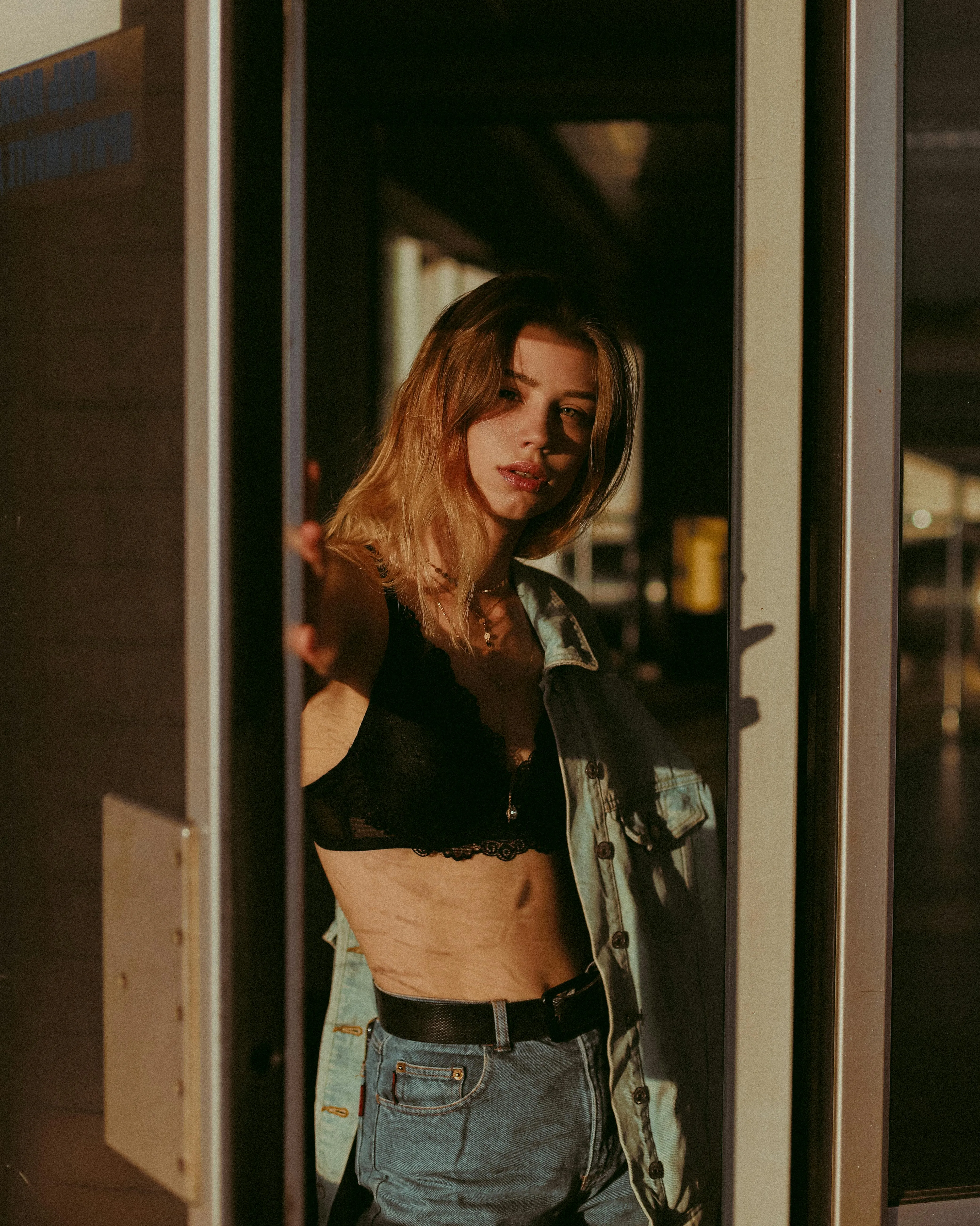 Fashionable Woman in Sunlight Wearing a Black Top and Jeans
