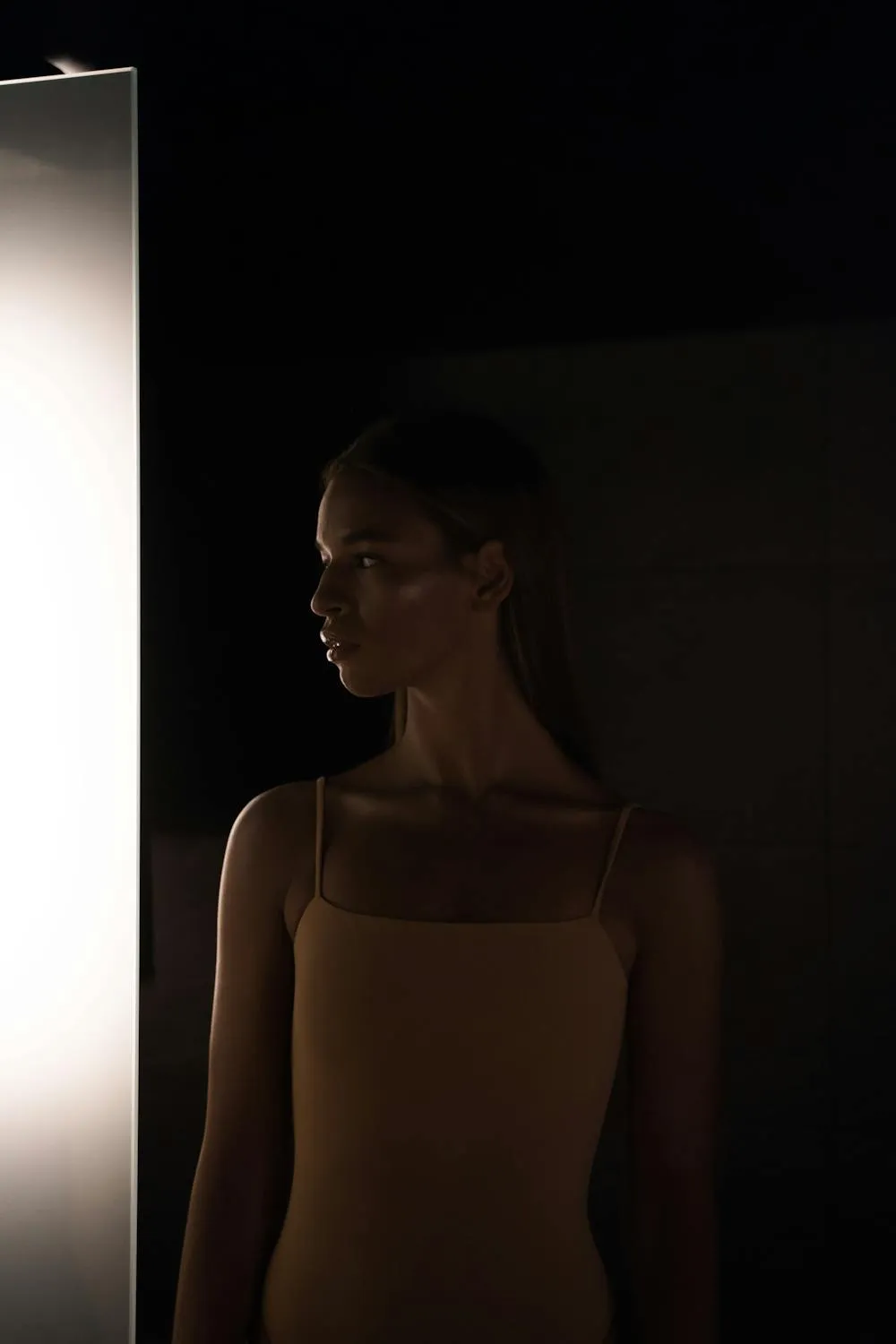 Fearless Woman in Glasses Standing in the Dramatic Lighting