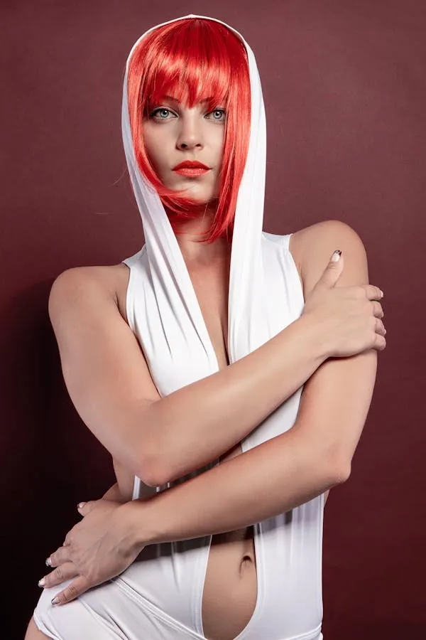 Female Model with a Bright Red Wig and a White Hooded Outfit