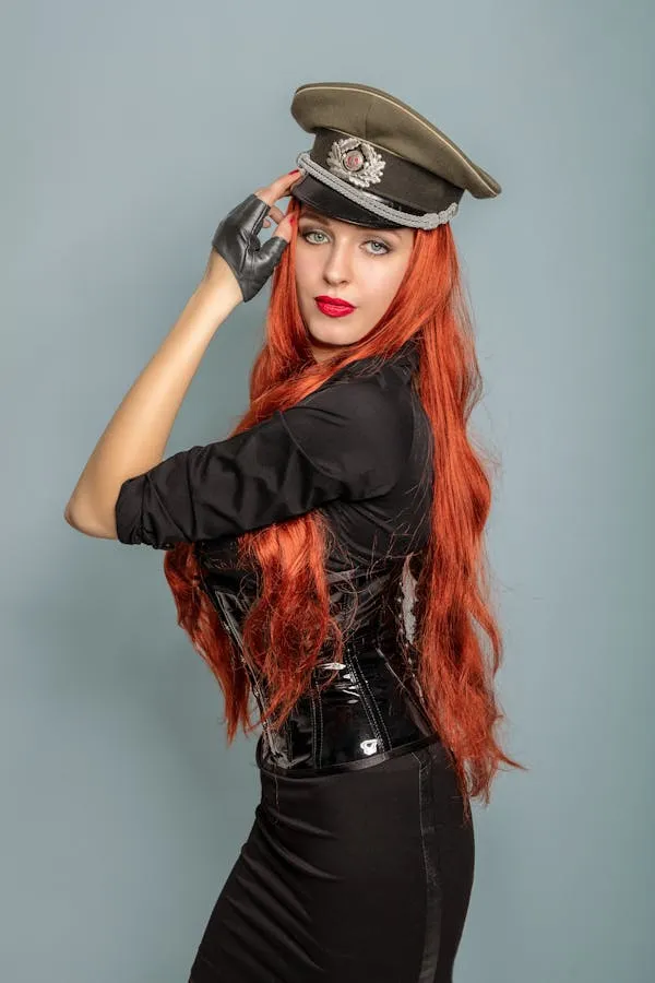 Female Model in a Military Style Hat and Long Red Hair Image