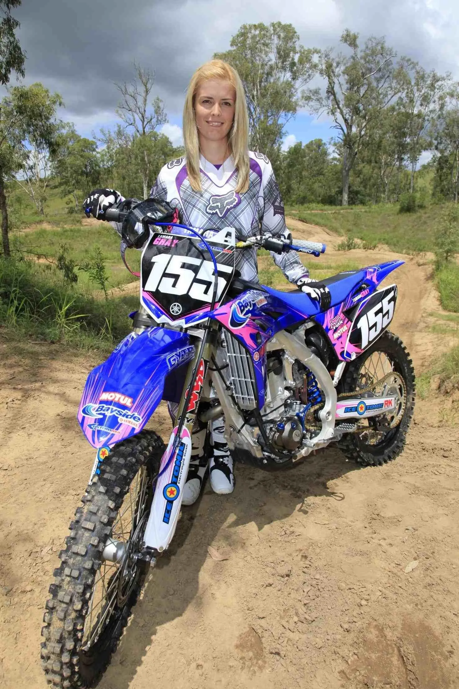 Female Model Motocross Rider Poses in Full Gear on Her Bike