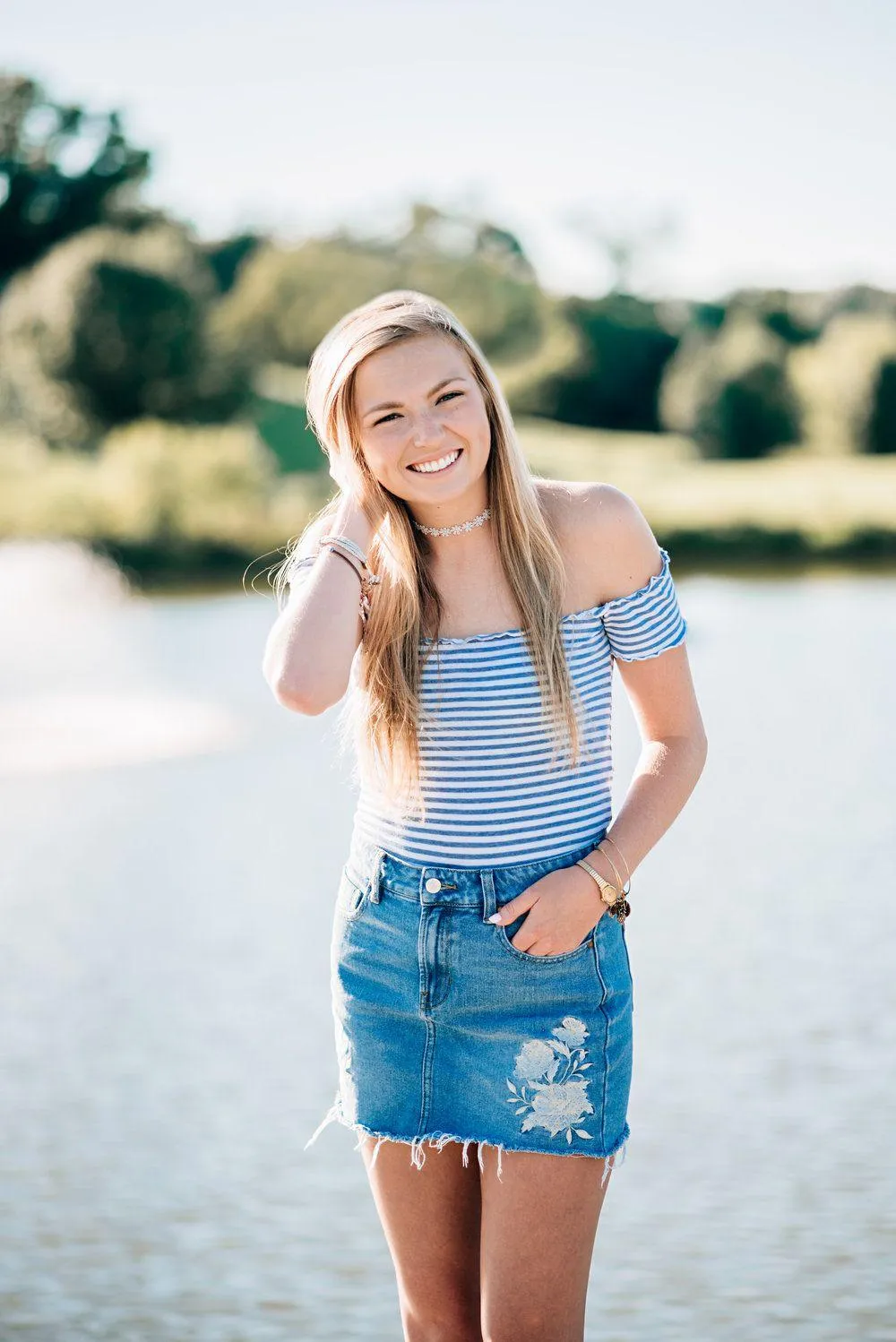Female Model Smiling and Posing on a Sunny Riverside Path