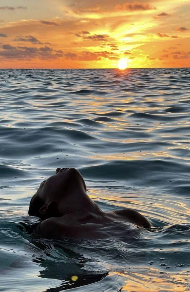 Female Model Swimming Alone During a Peaceful Ocean Sunset