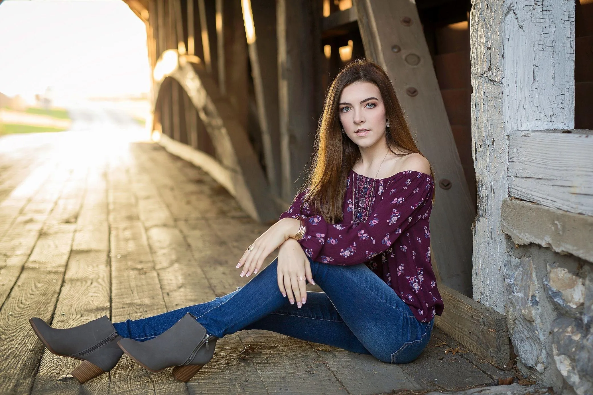 Fit Woman Standing Beside a Classic Red Motorcycle Outside