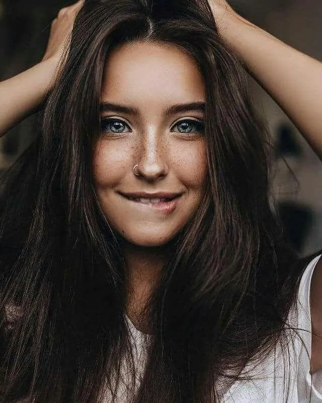 Girl Sitting on Classic Motorcycle in Forest Light Wallpaper