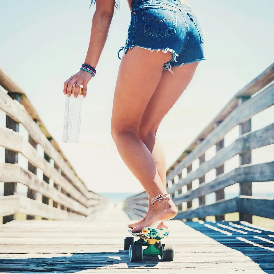 Girl Skating on the Boardwalk in Shorts with Summer Sunshine