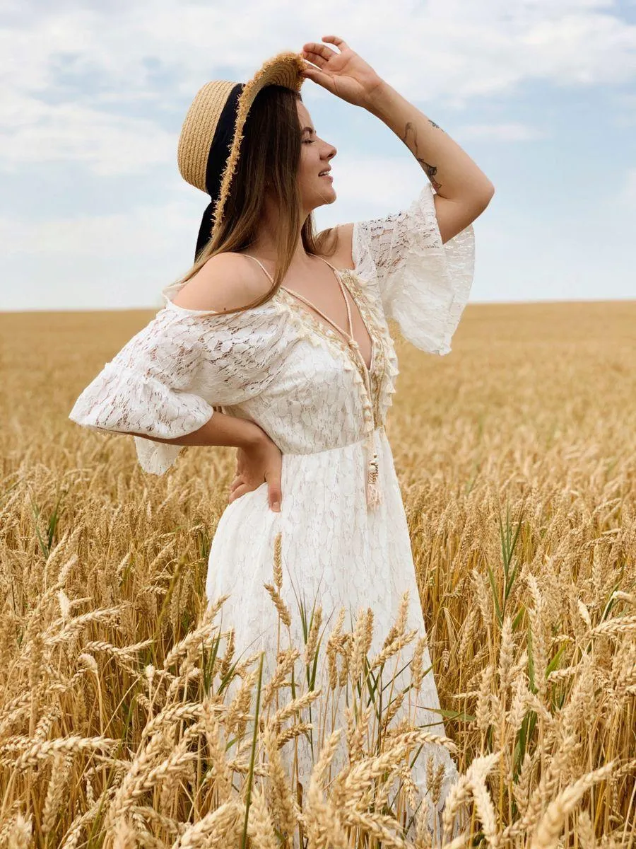 Girl Standing in a Wheat Field Wearing a Flowy White Dress