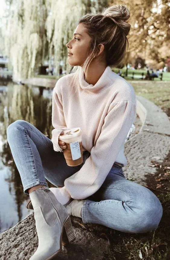 Girl in a White Hoodie Is Relaxing on a Bench Outdoors Image