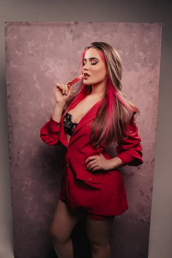 Glamorous Model Posing Confidently in a Red Blazer Dress