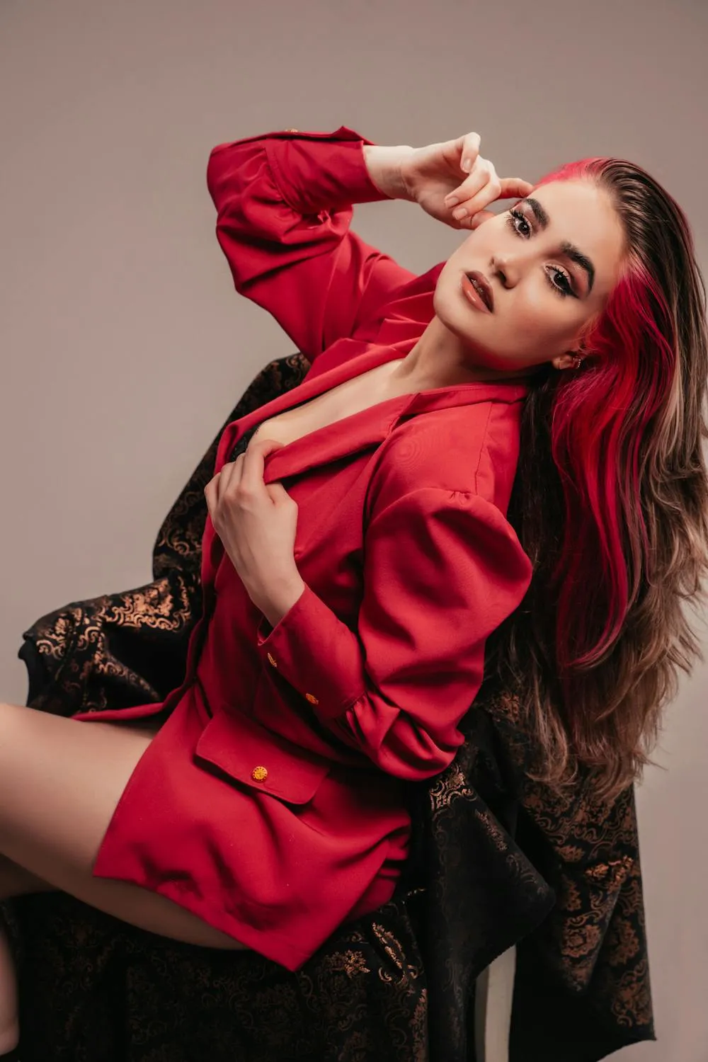 Glamorous Red Haired Model in Striking Red Fashion Outfit