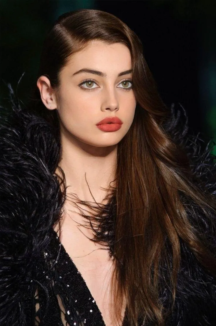 Glamorous Woman with Dark Hair Wearing Elegant Evening Dress