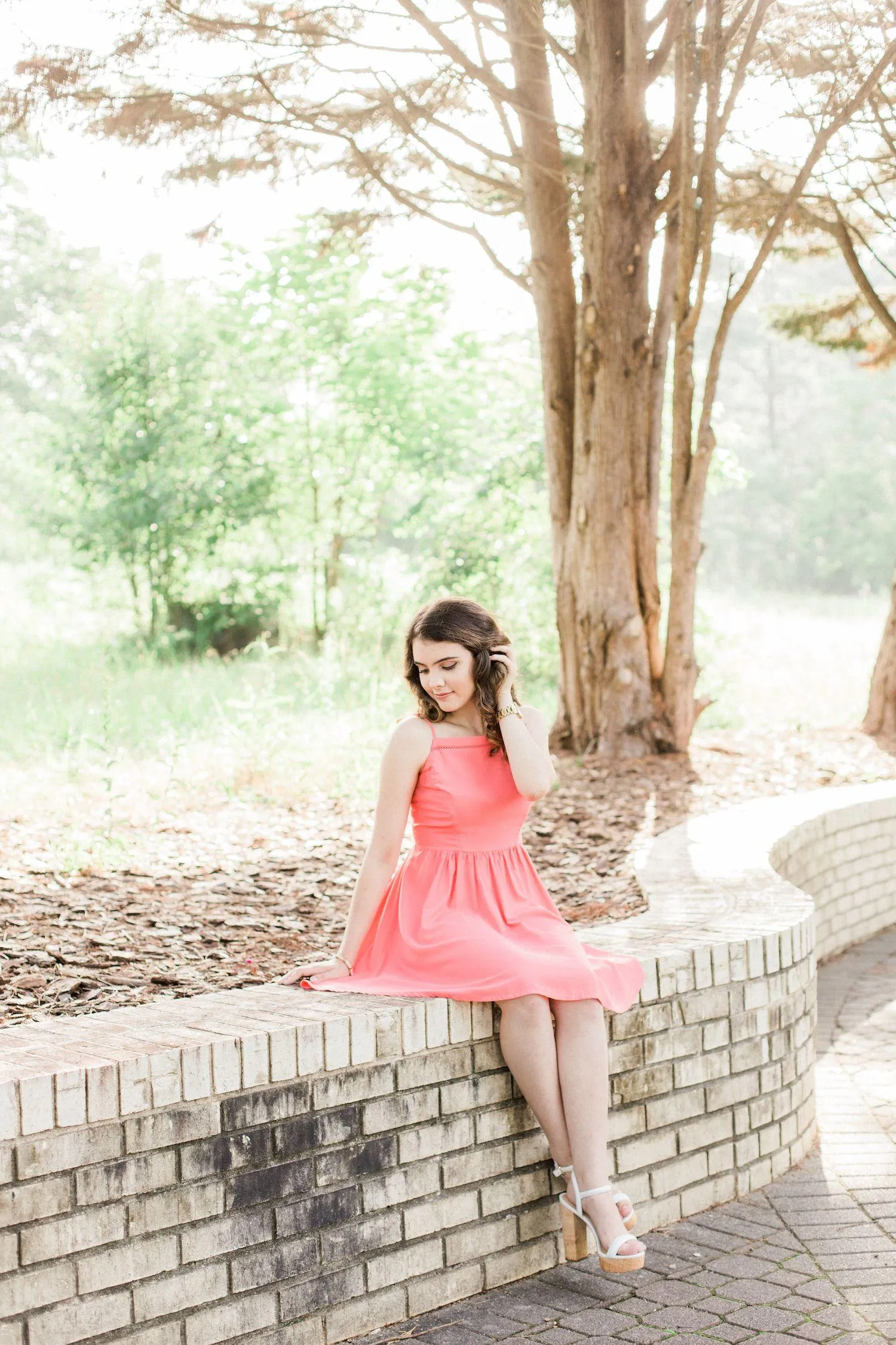 Glamorous Woman Posing with Her Hand Up in Golden Lighting