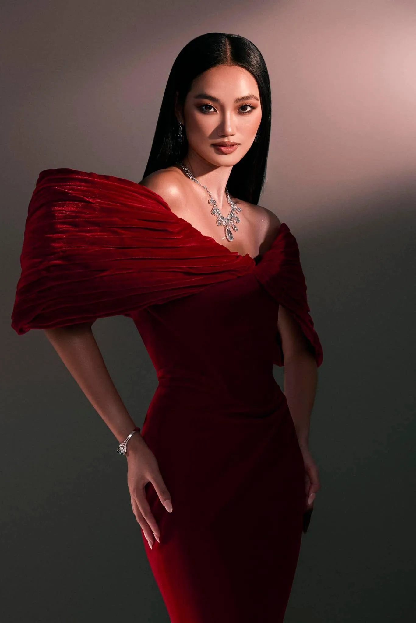 Glamorous Woman Wearing Red Dress Posing in a Studio Setting