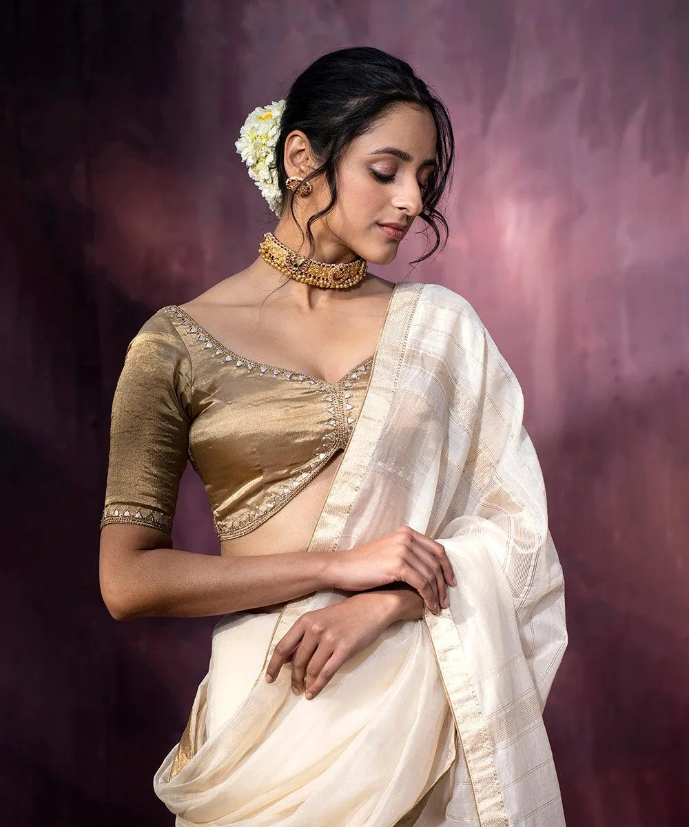 Gorgeous Woman in Cream Saree with Graceful Smile Wallpaper