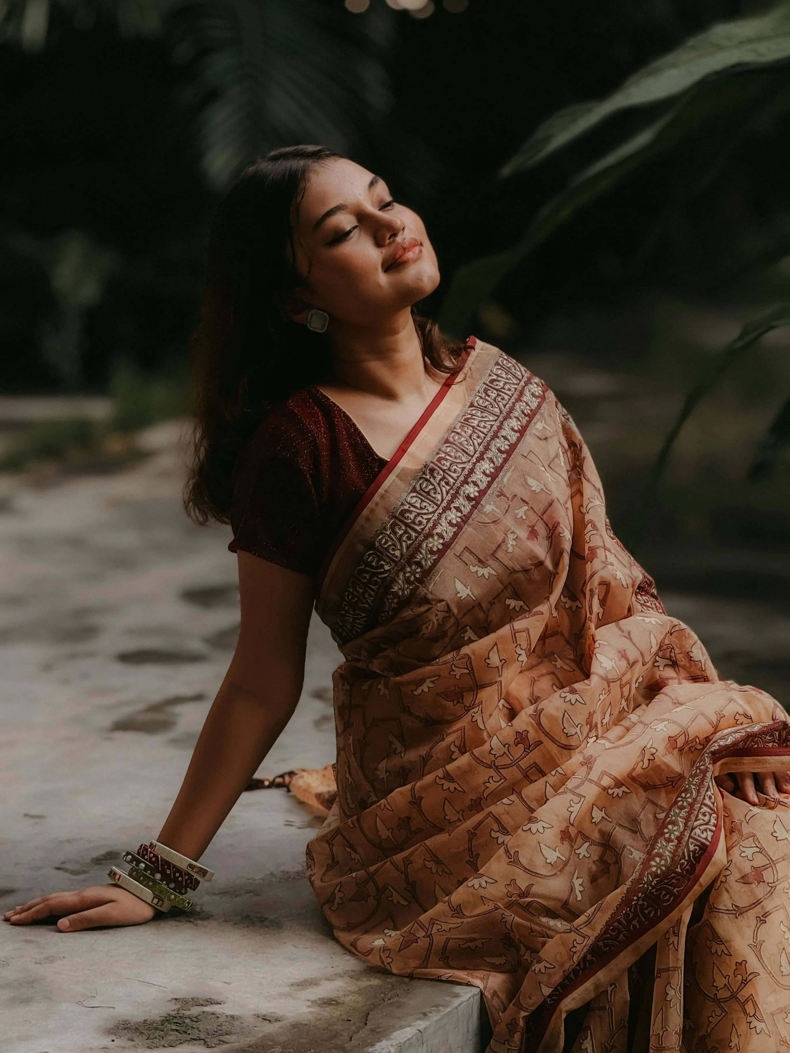 Gorgeous Young Woman in Brown Saree Seated on Ground Pose
