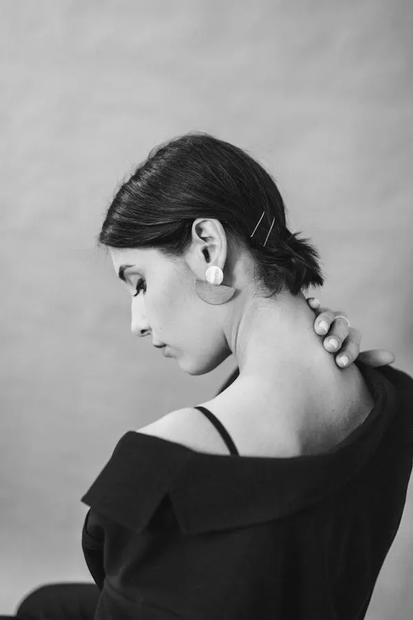 Graceful Woman in a Black Top with Head Down Free Wallpaper