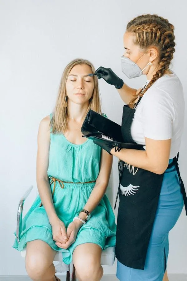 Hairstylist Working on a Woman in Turquoise Dress in Studio