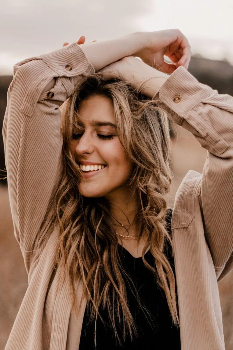 Happy Woman in a Oversized Sweater with Closed Eyes Smiling