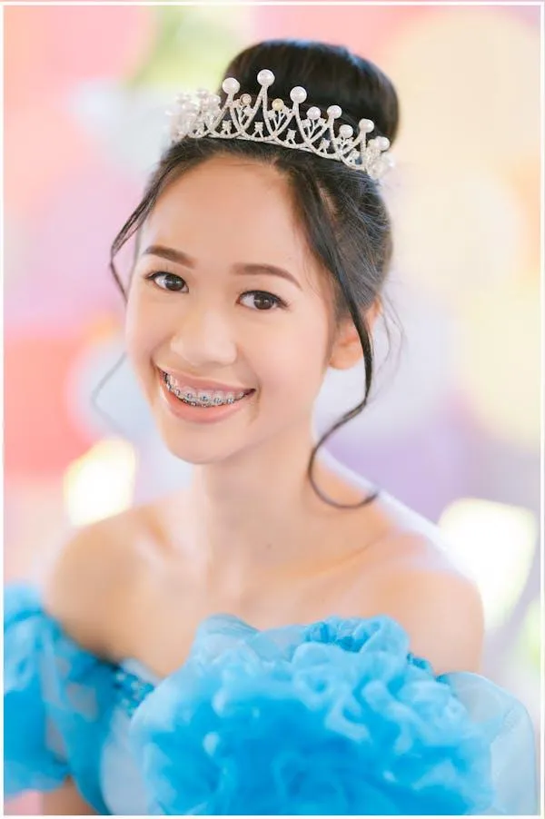 Happy Young Woman in a Blue Dress and Silver Tiara Wallpaper